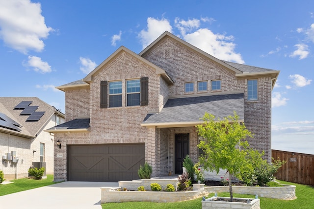view of front of property featuring central AC, concrete driveway, fence, a garage, and brick siding