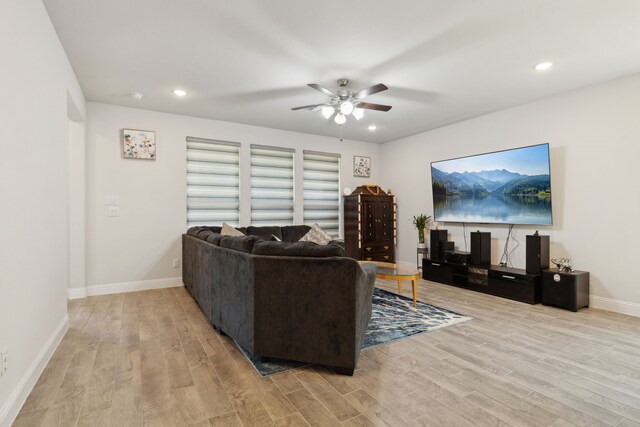 living area featuring recessed lighting, wood finished floors, a ceiling fan, and baseboards