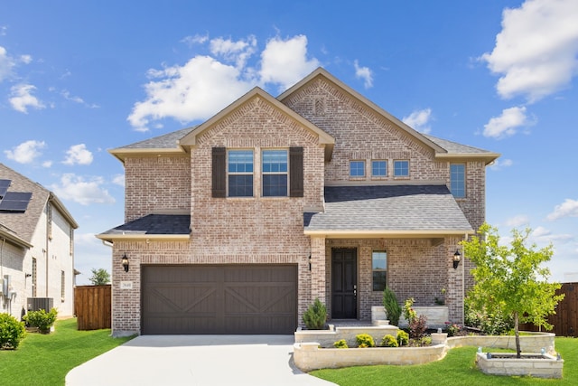view of front of house featuring fence, concrete driveway, an attached garage, brick siding, and a front yard