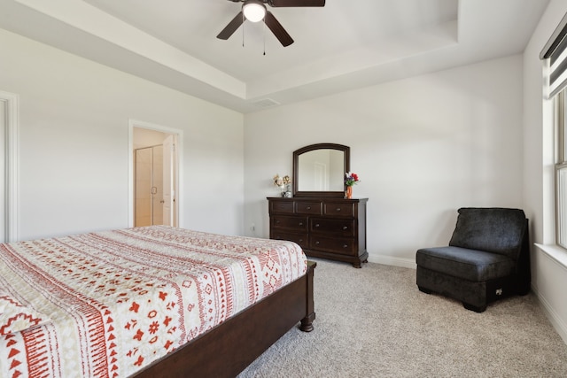 bedroom with baseboards, visible vents, carpet, a ceiling fan, and a raised ceiling