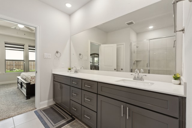 full bathroom featuring a shower stall, double vanity, visible vents, a sink, and ensuite bathroom