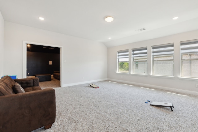 carpeted living area featuring baseboards, visible vents, and recessed lighting