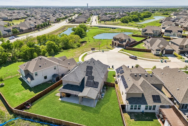 drone / aerial view with a residential view and a water view