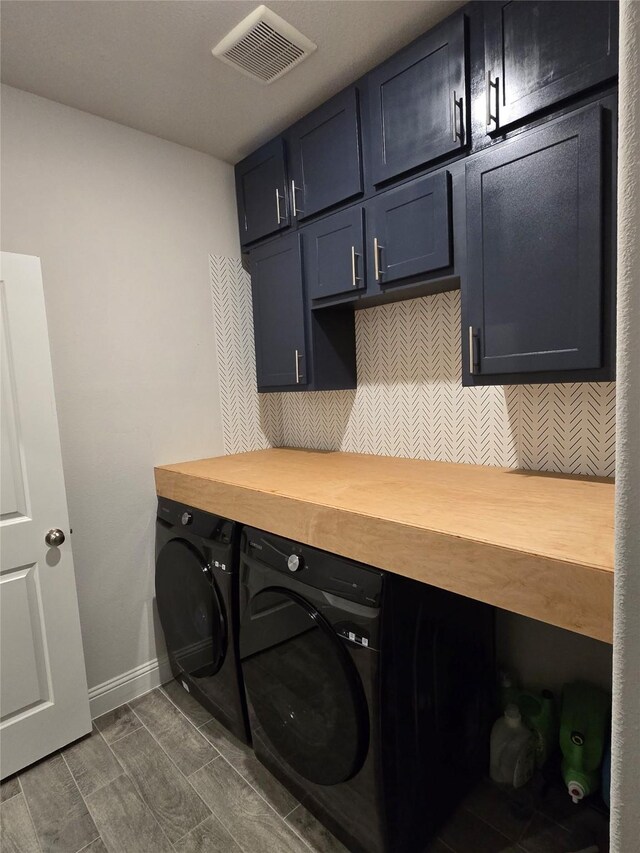 laundry room with baseboards, cabinet space, washer and clothes dryer, and visible vents