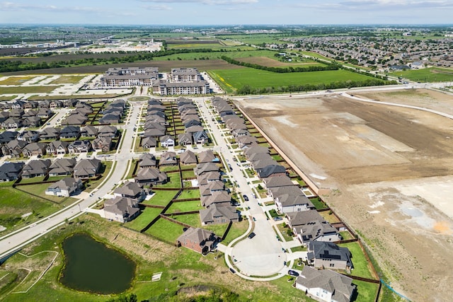 birds eye view of property with a water view and a residential view