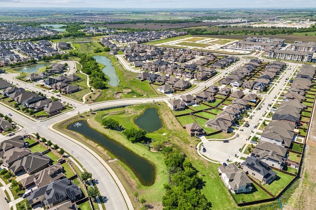 drone / aerial view with a water view and a residential view