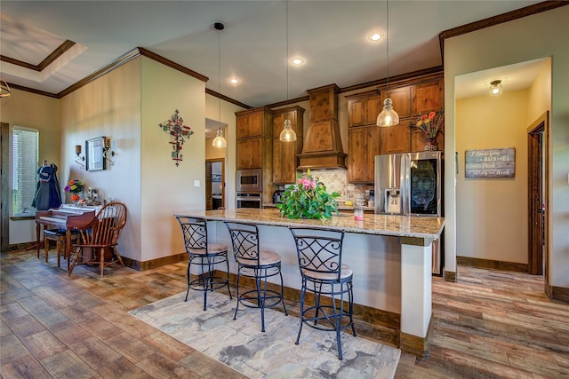 kitchen with hardwood / wood-style floors, premium range hood, crown molding, baseboards, and appliances with stainless steel finishes