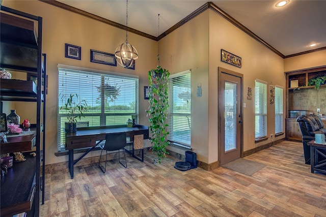 office area featuring plenty of natural light, wood finished floors, an inviting chandelier, and ornamental molding