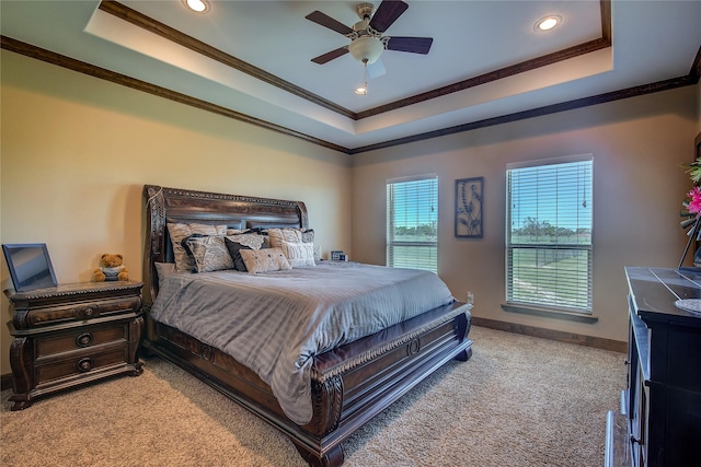 bedroom with light carpet, crown molding, a tray ceiling, and recessed lighting