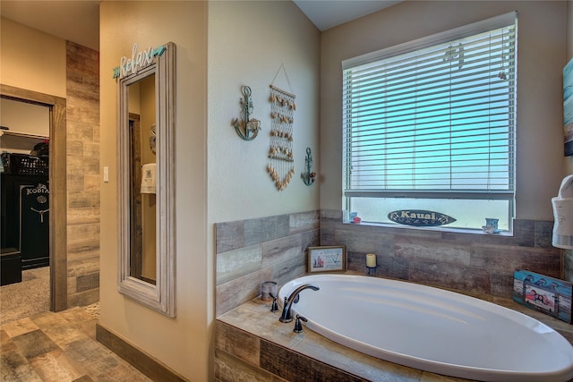 full bath featuring wood finished floors and a garden tub