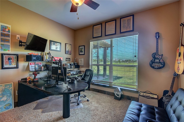 carpeted office space featuring ceiling fan