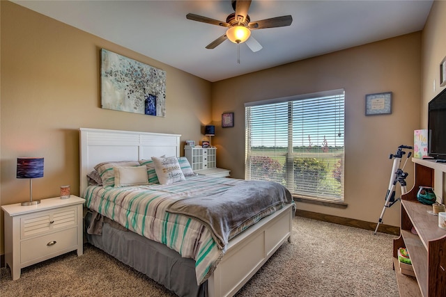 bedroom featuring light carpet, baseboards, and ceiling fan