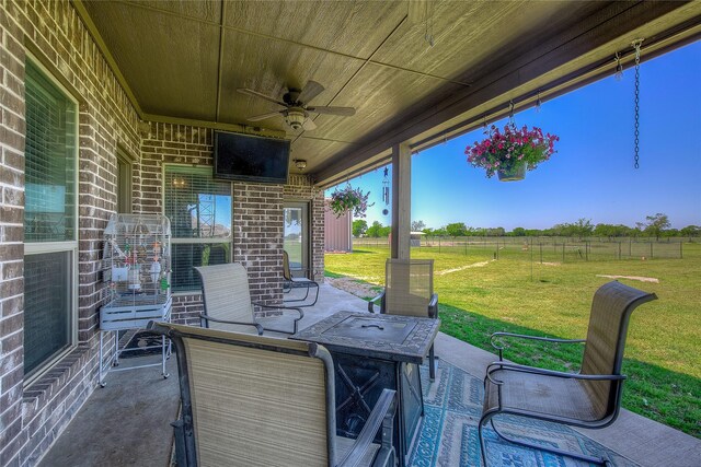 view of patio / terrace with fence and a ceiling fan