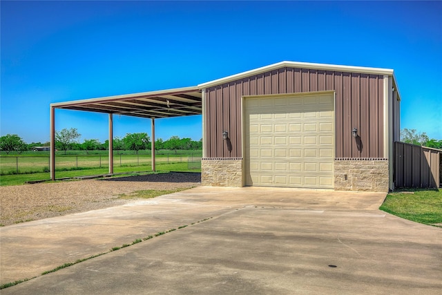 exterior space with fence, driveway, and a garage