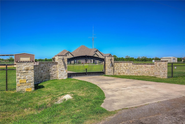 view of gate with a lawn and fence private yard