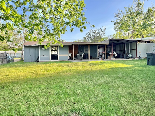 back of house featuring a lawn and fence