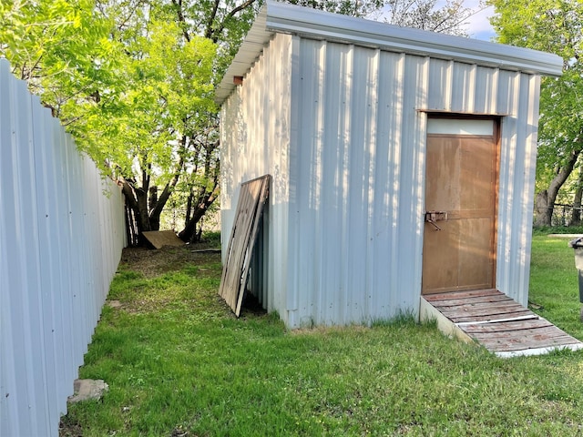 view of shed with fence