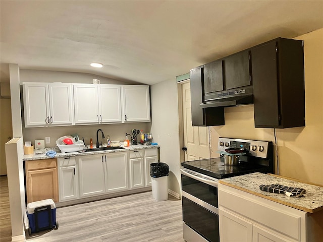 kitchen featuring white cabinets, stainless steel range with electric cooktop, light wood-type flooring, lofted ceiling, and under cabinet range hood