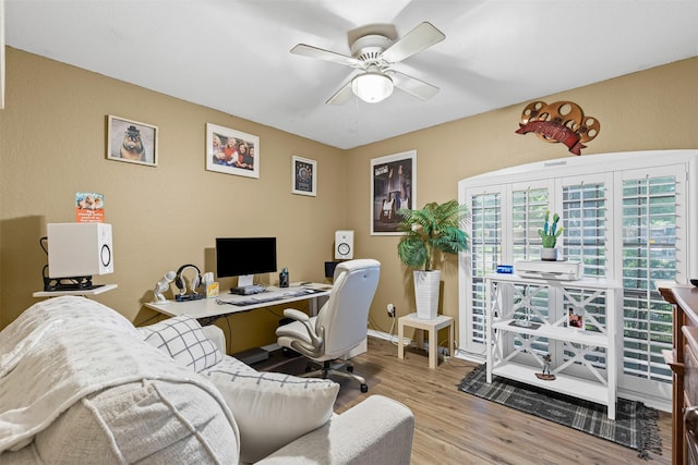 home office featuring ceiling fan, baseboards, and wood finished floors