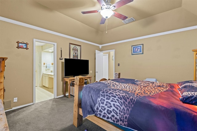 bedroom with ensuite bath, a raised ceiling, visible vents, and carpet flooring