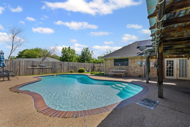 view of pool with a fenced backyard, a fenced in pool, french doors, and a patio