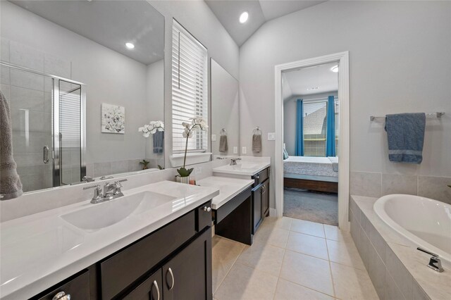 ensuite bathroom featuring a bath, tile patterned flooring, vanity, and a stall shower