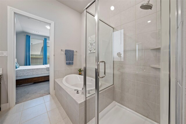 ensuite bathroom with a shower stall, a bath, tile patterned flooring, and connected bathroom