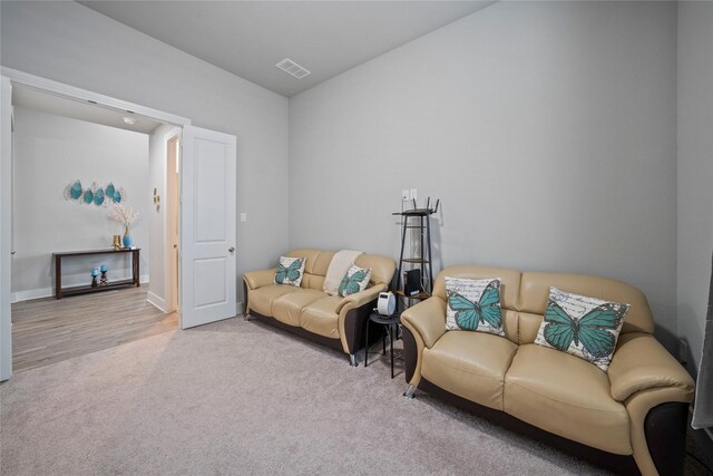 carpeted living area with visible vents