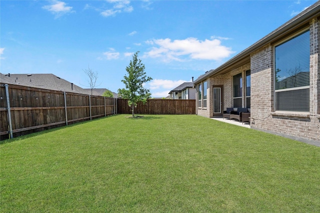 view of yard with a patio area and a fenced backyard