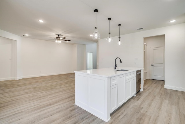 kitchen with a ceiling fan, a sink, light wood finished floors, white cabinetry, and visible vents