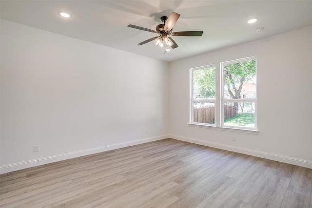unfurnished room featuring recessed lighting, light wood-type flooring, a ceiling fan, and baseboards