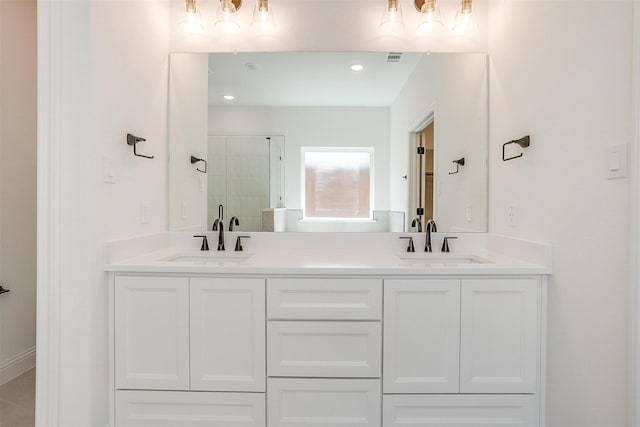 bathroom with visible vents, a sink, double vanity, and a stall shower