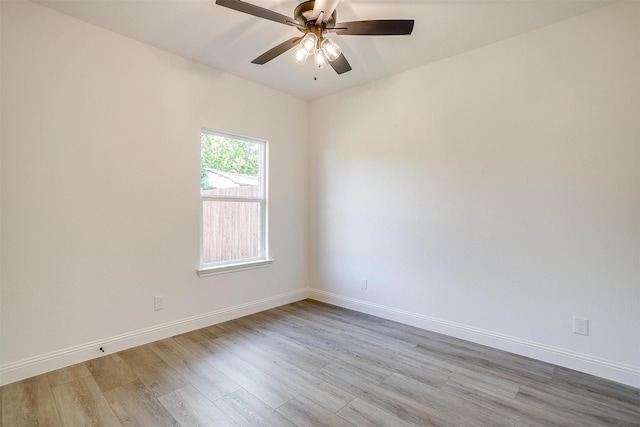empty room featuring ceiling fan, baseboards, and light wood-type flooring