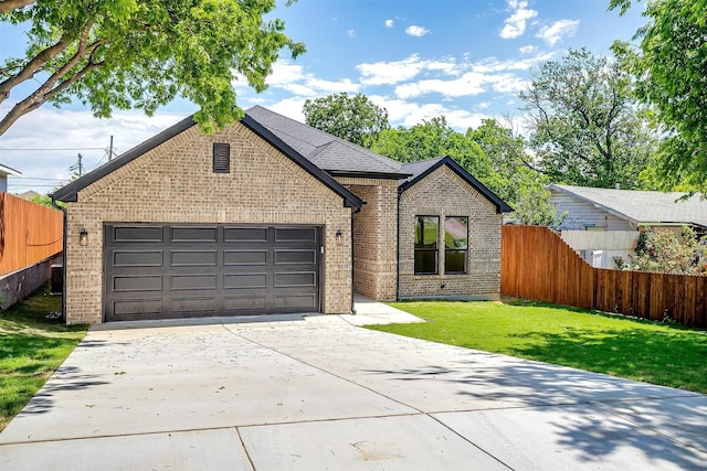 view of front of home featuring an attached garage, brick siding, fence, and driveway