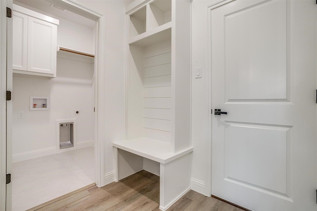 mudroom with light wood-style flooring and baseboards