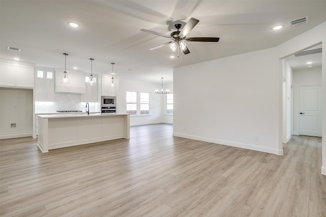 unfurnished living room with recessed lighting and visible vents