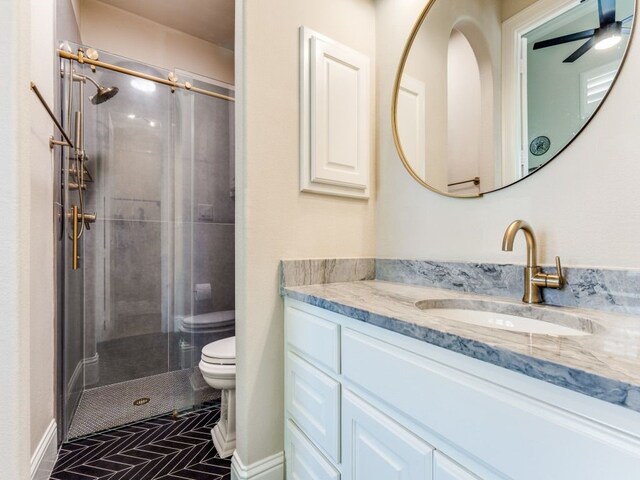 bathroom with vanity, toilet, and a shower stall