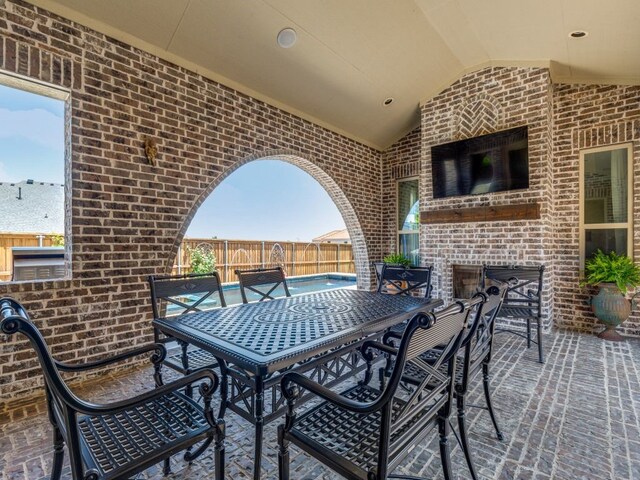 view of patio with outdoor dining space and fence