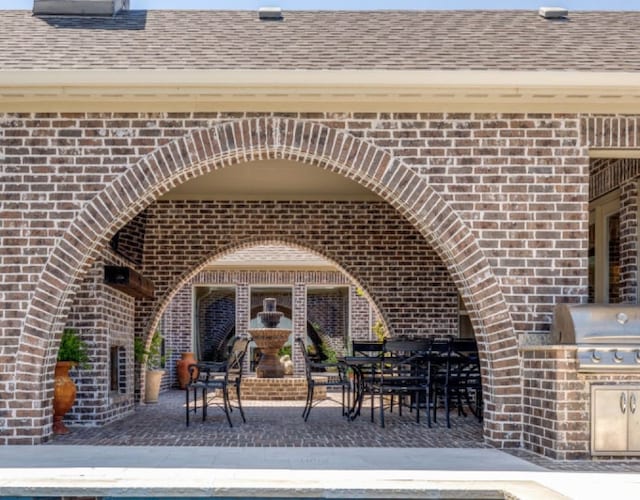view of patio featuring exterior kitchen and area for grilling
