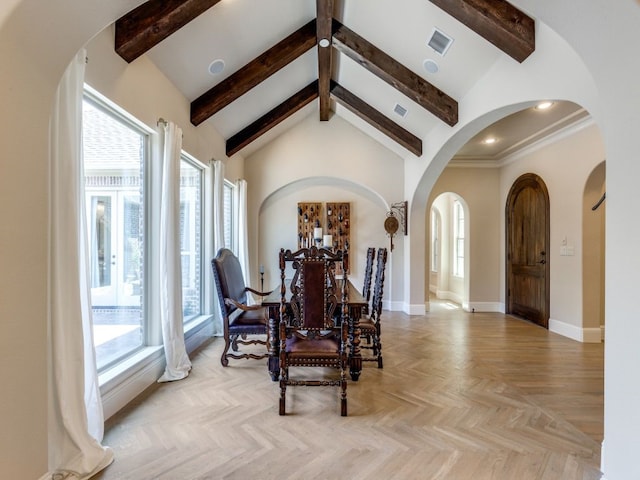 dining room with arched walkways, visible vents, beam ceiling, and baseboards