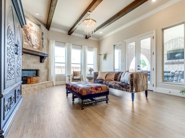living room featuring arched walkways, light wood finished floors, baseboards, beam ceiling, and visible vents