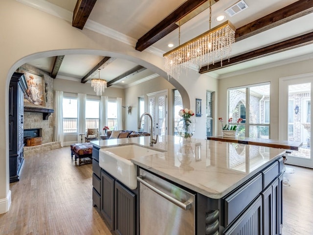 kitchen with visible vents, beam ceiling, open floor plan, dishwasher, and a notable chandelier