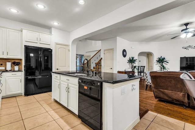 14208 Rising Star Blvd, Frisco, TX 75033 - kitchen featuring black appliances, arched walkways, a sink, open floor plan, and light tile patterned floors