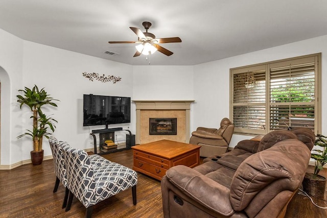 14208 Rising Star Blvd, Frisco, TX 75033 - living room featuring arched walkways, a ceiling fan, wood finished floors, and a tiled fireplace