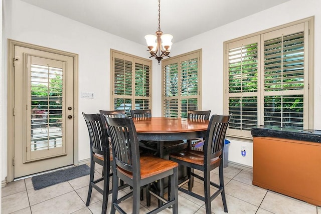 dining room featuring light tile patterned flooring and a notable chandelier