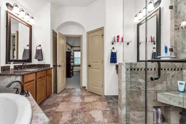 full bath with a bathing tub, tiled shower, vanity, and baseboards