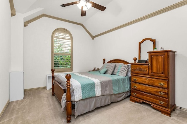 bedroom featuring ornamental molding, ceiling fan, vaulted ceiling, and light colored carpet