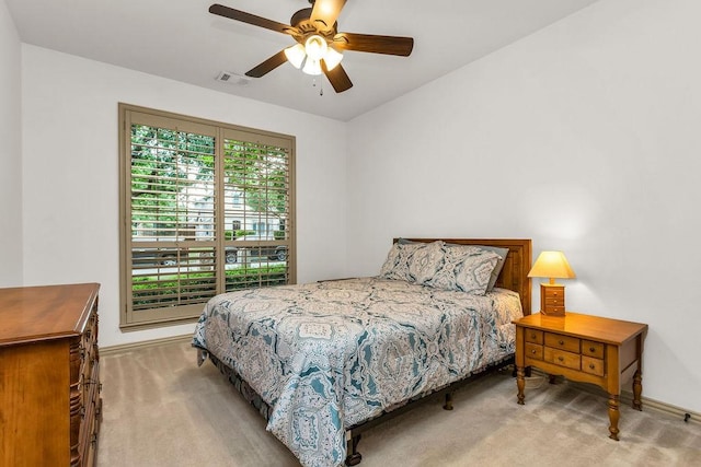 carpeted bedroom featuring visible vents, ceiling fan, and baseboards