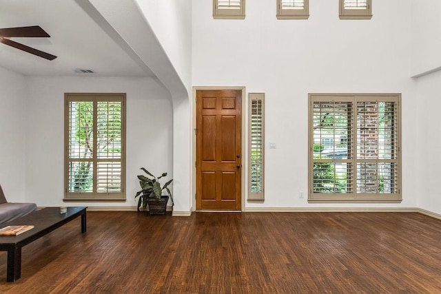 entrance foyer featuring visible vents, a ceiling fan, dark wood-style floors, and baseboards
