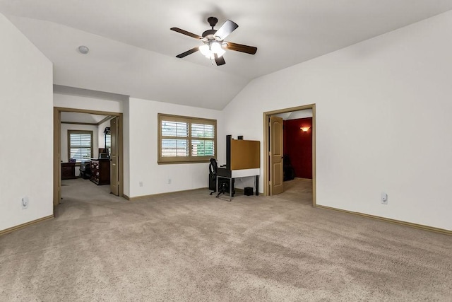living room featuring lofted ceiling, light colored carpet, ceiling fan, and baseboards